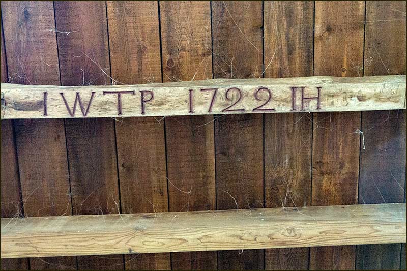 The carving on a beam in a side aisle